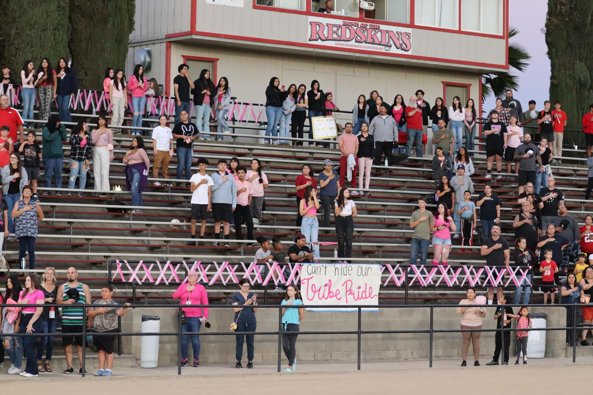 players, cheerleaders, and officials preparing for the powderpuff football game