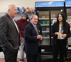 Two men and one woman in a kitchen
