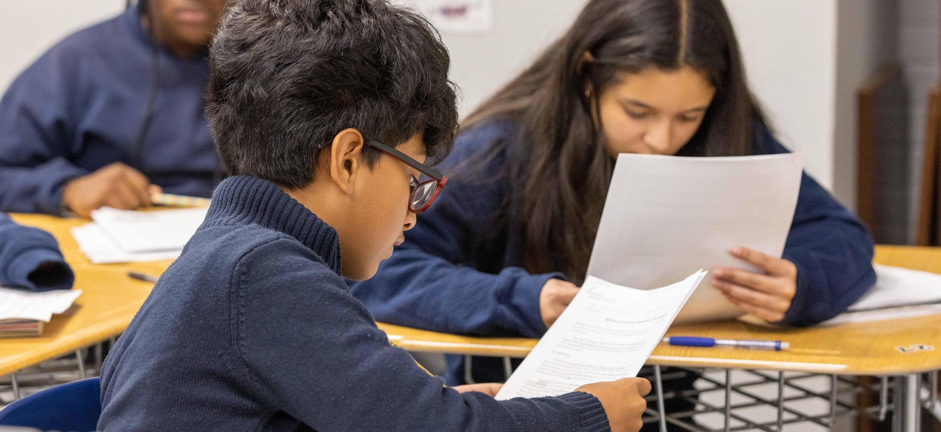Scholars at work, writing and reading.