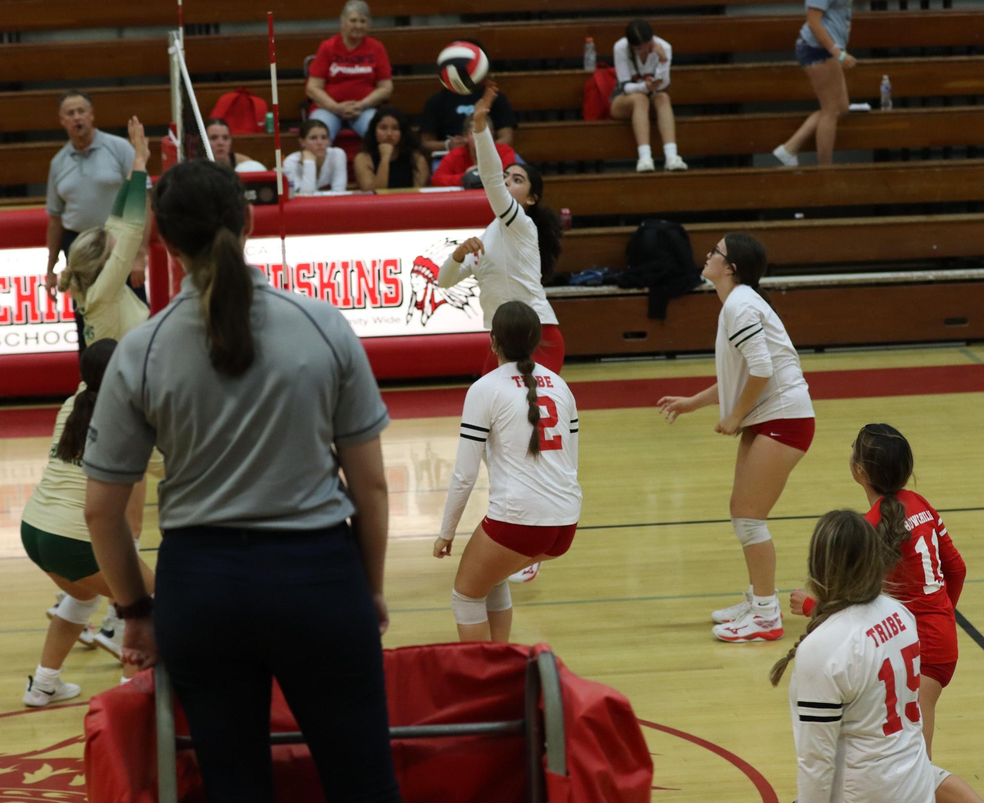 varsity volleyball players in action against liberty