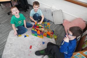 Three boys build a house for a mutant dinosaur.