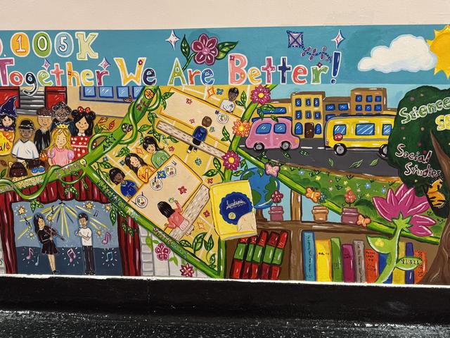 Colorful mural celebrating community and education with children and books.