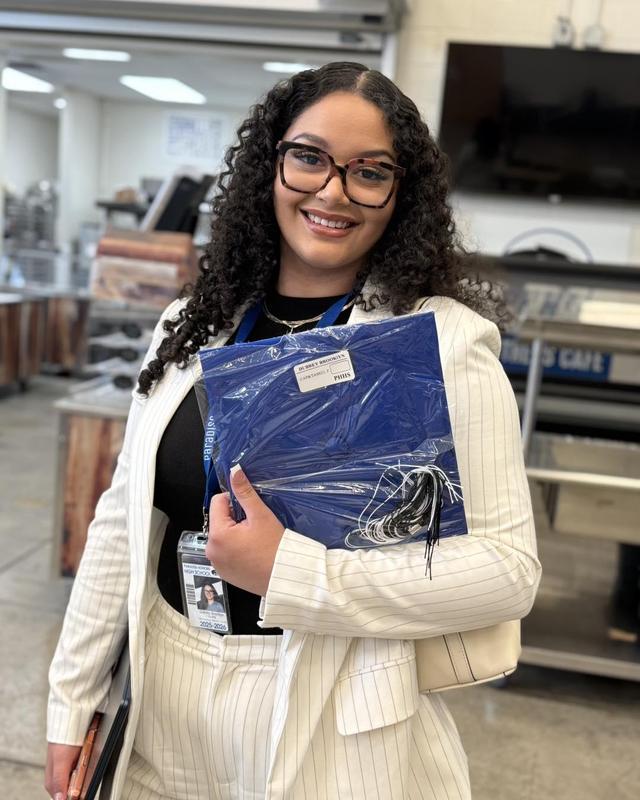 photo of girl holding cap and gown
