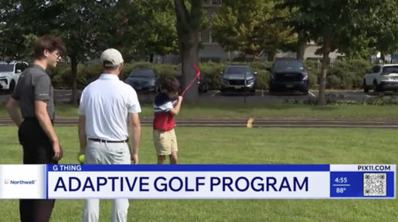 two instructors watch as a boy swings the golf club on a field