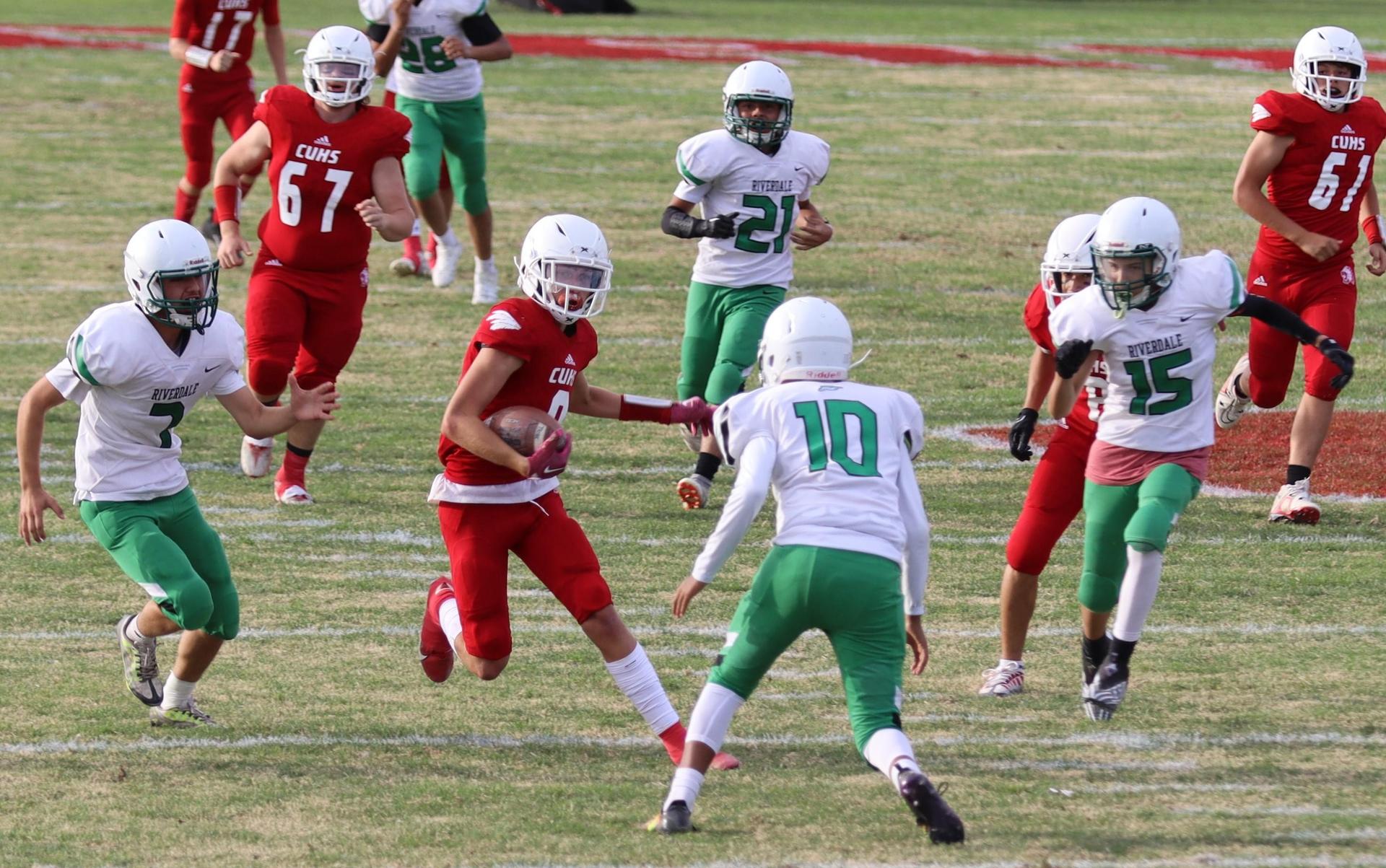  junior varsity football players in action against riverdale