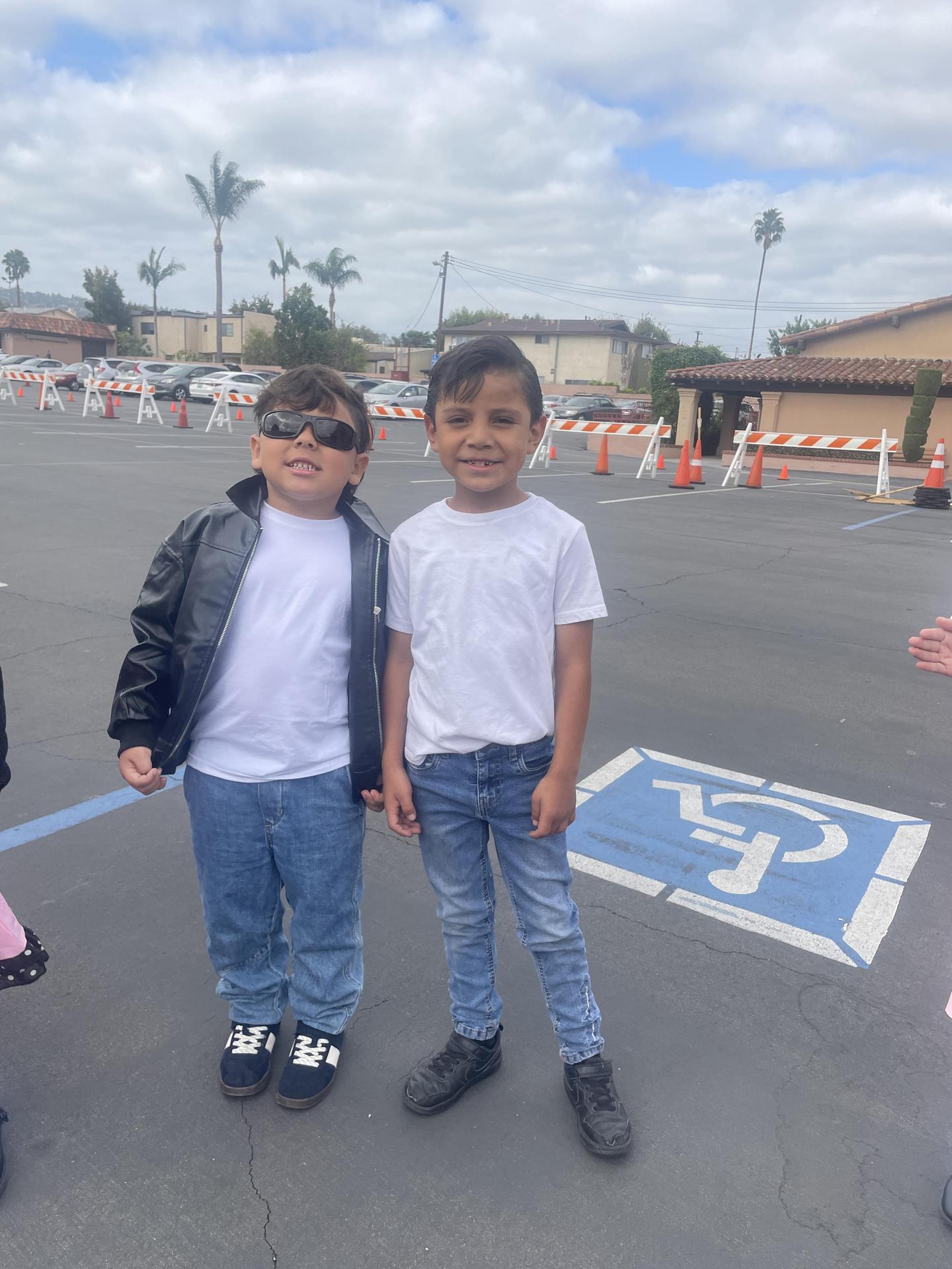 two young boys wearing white and black