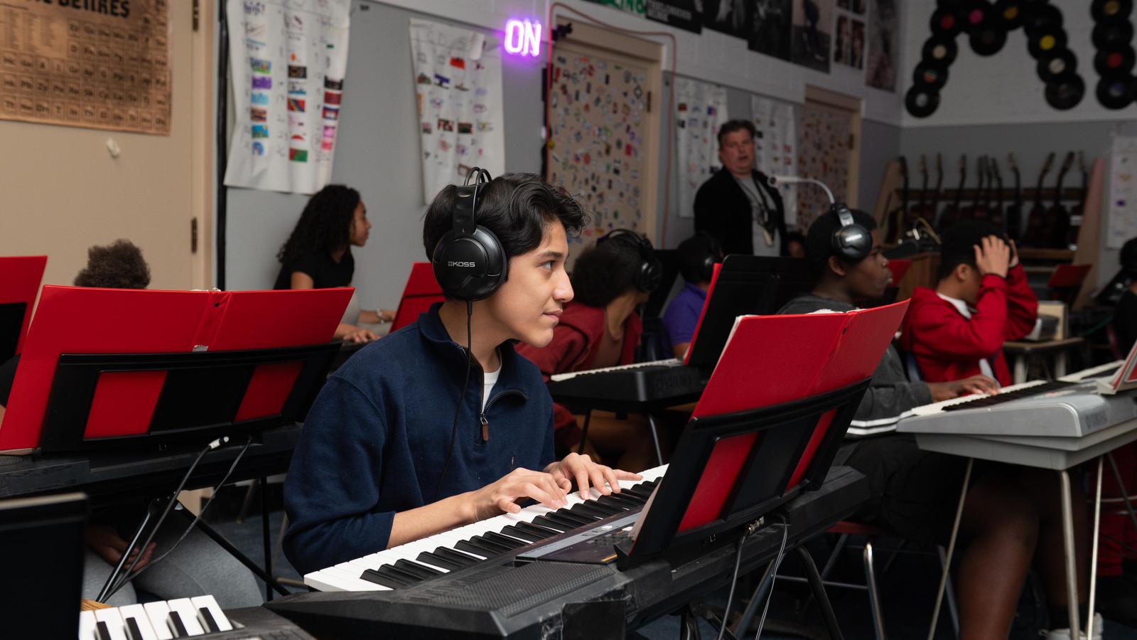 Student playing the electric keyboard in class