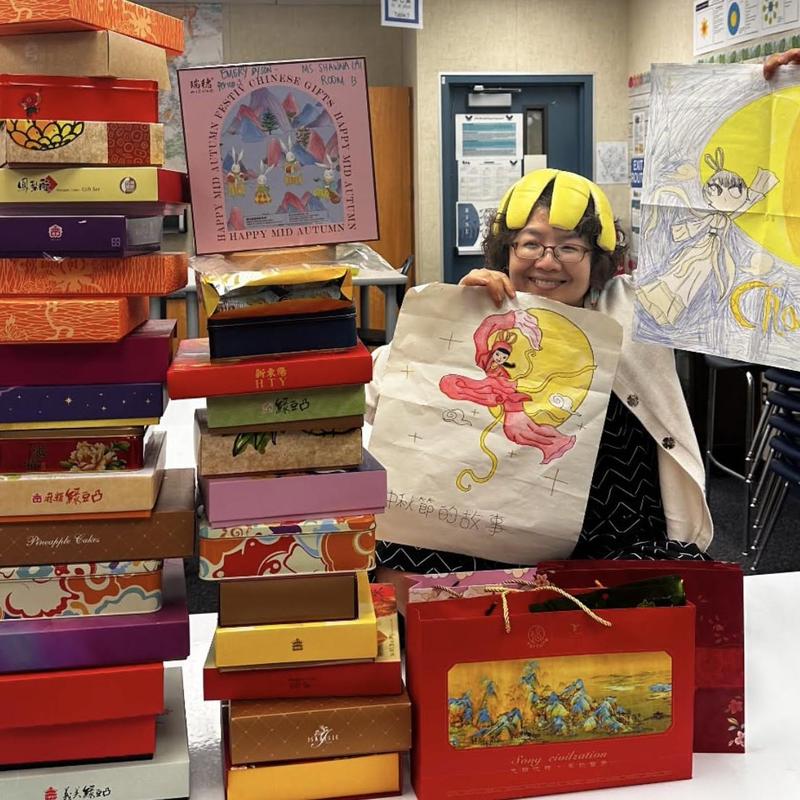 miss shawna with a stack of gift from parents