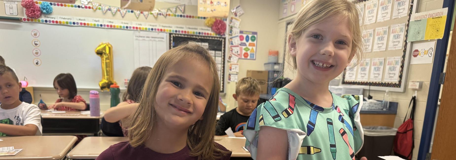 2 girls smiling for the camera