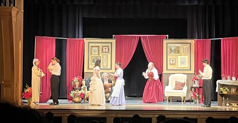 Theatrical performance on stage with actors in costume and a richly decorated set.