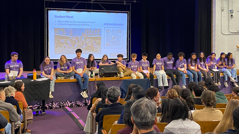 Upper Grades students answer questions from parents and students during an Open House session.