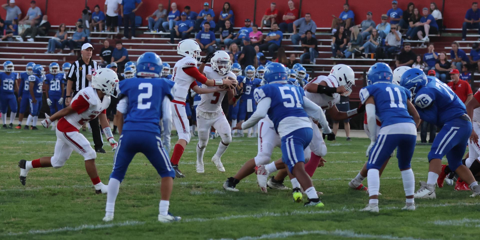 Junior Varsity football players in action against Caruthers