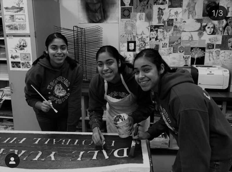 Students painting a sign