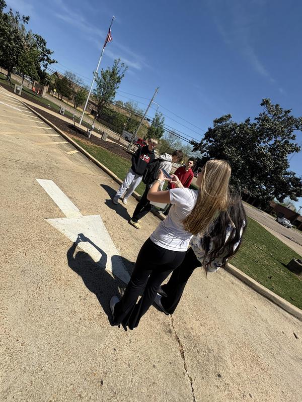 Students looking for polygons at the front of campus