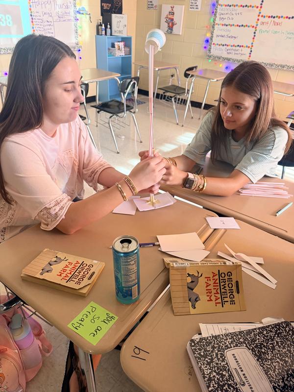 working together two student put the pieces together