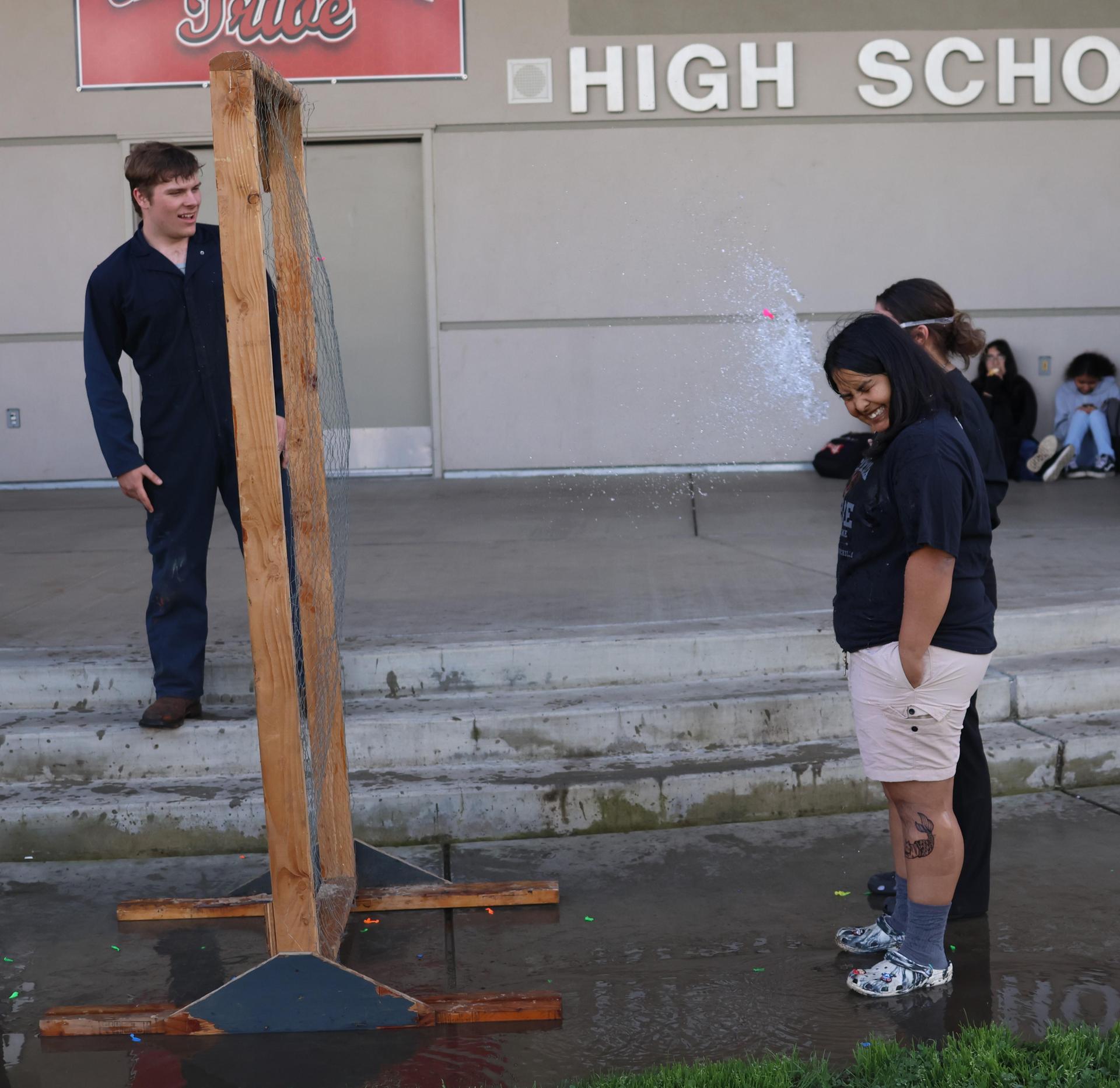 students and staff enjoying the water balloon toss