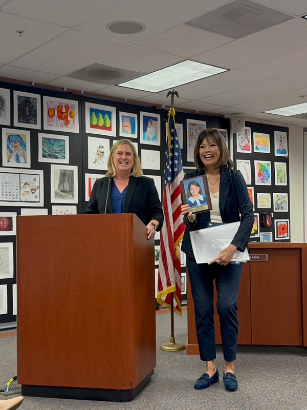 Principal and Superintendent giving out awards