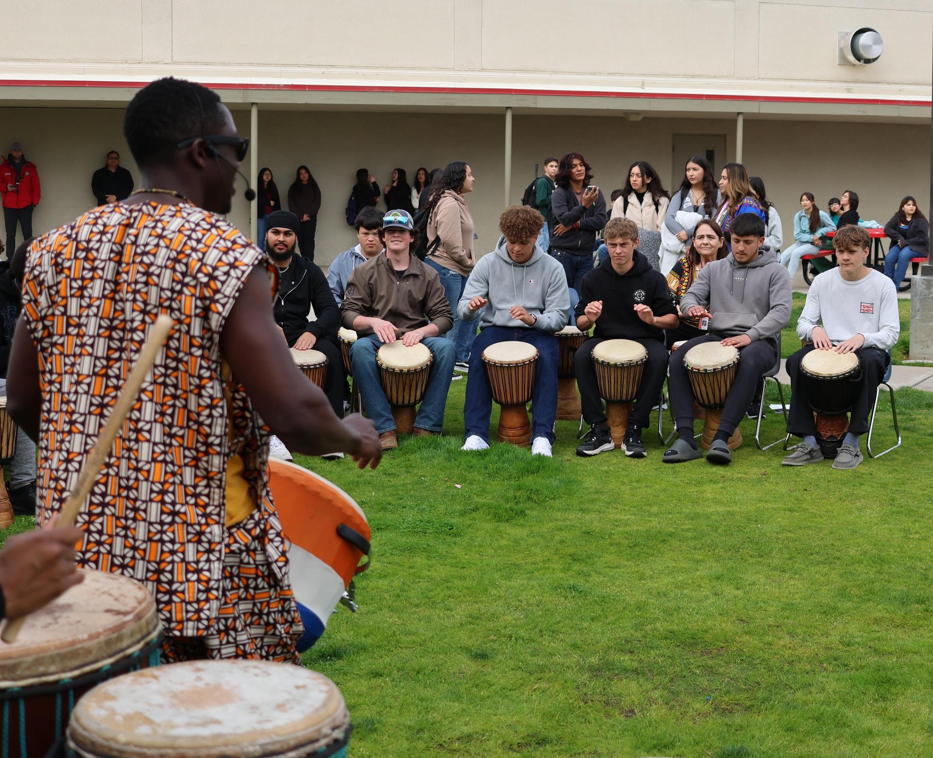 students and staff participating with the African Drum Interactive
