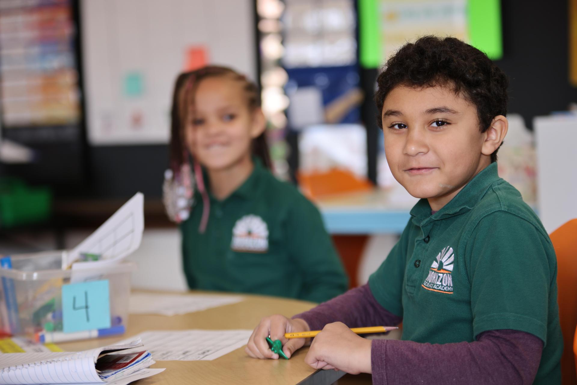 HSA Davenport student wearing headphones uses a laptop in class