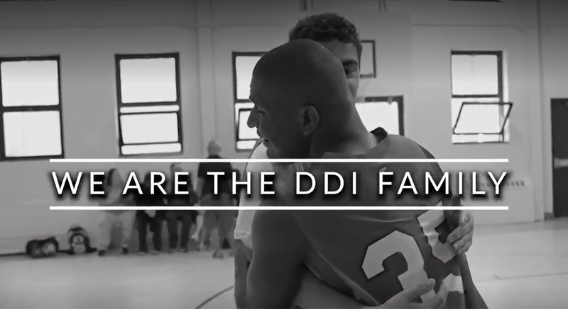 Two basketball players hugging