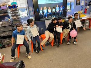 3B boys wobble to show how sound waves move through the air.