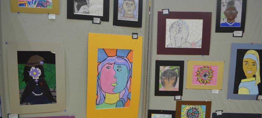 student drawings and paintings on display