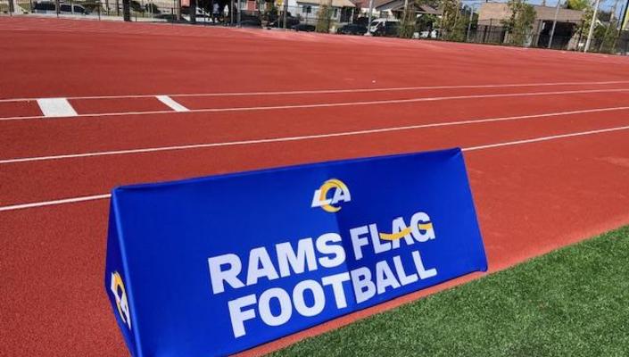 Picture of Rams Flag Football logo sign on track field