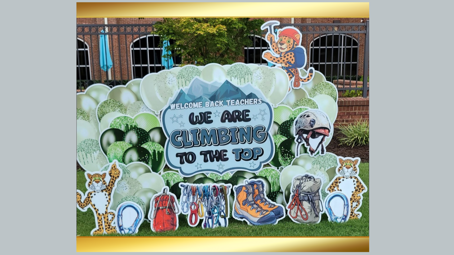 Colorful welcome display with climbing theme and characters for teachers.