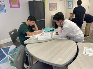8th grade boys learning about different types of governments
