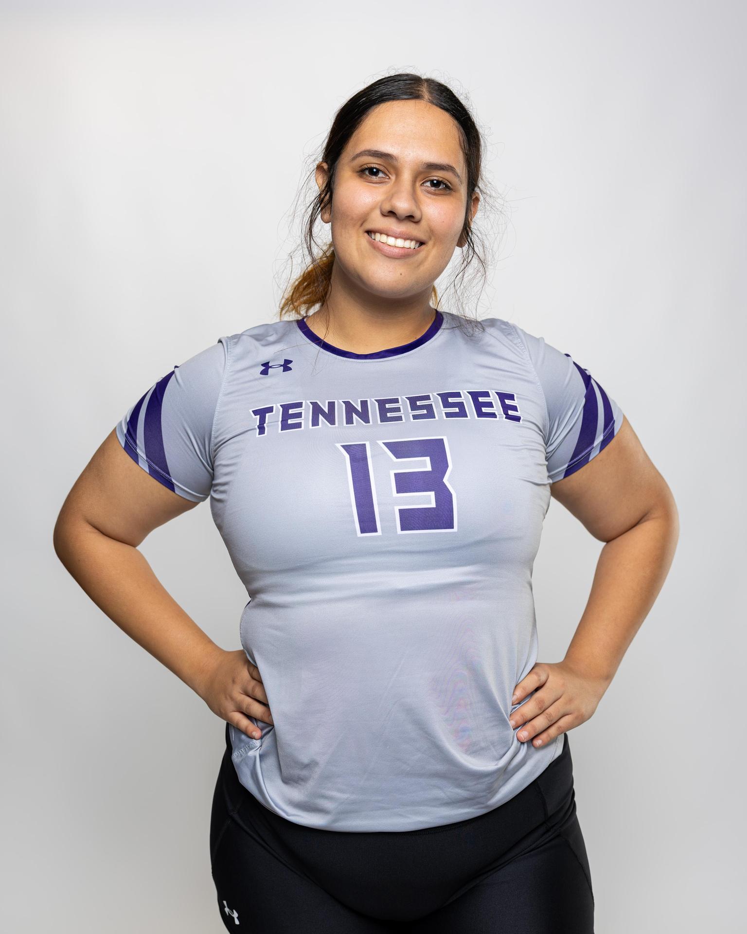 number 13 female volleyball player posing