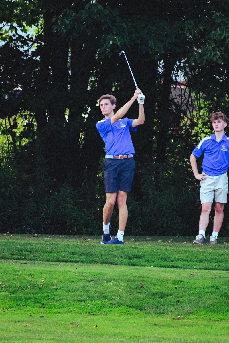 Boy golfing