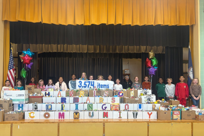 Students at David A. Harrison Elementary School pose with the over 3,500 canned and non-perishable food items collected during their yearly donation drive to benefit the Prince George County Food Bank on Friday, November 14, 2025.