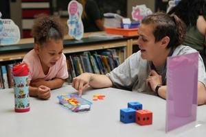 Student playing math game with parent