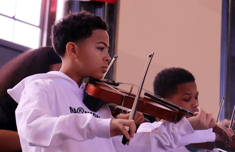 Two boys playing violin