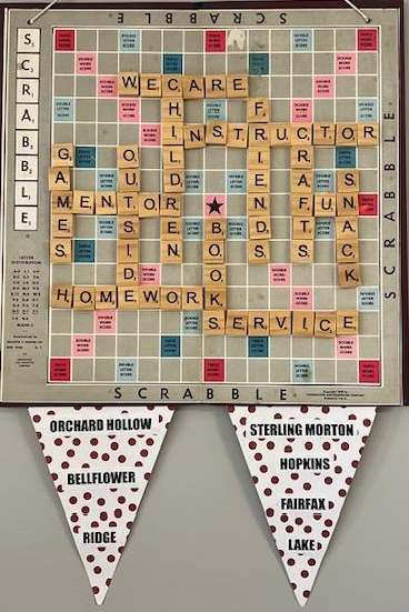 Scrabble board with words like 'children' and 'homework' and decorative banners below.