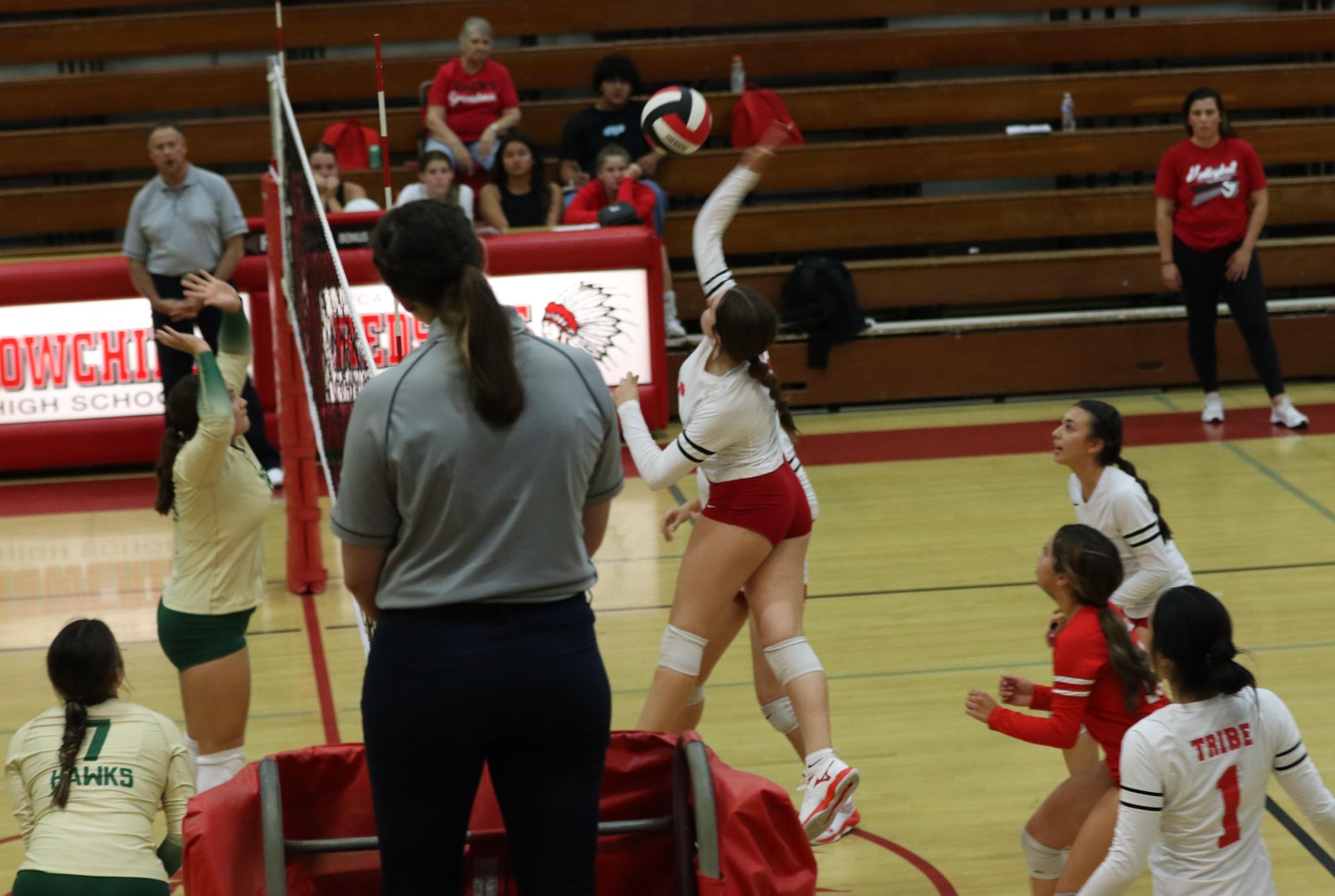 varsity volleyball players in action against liberty