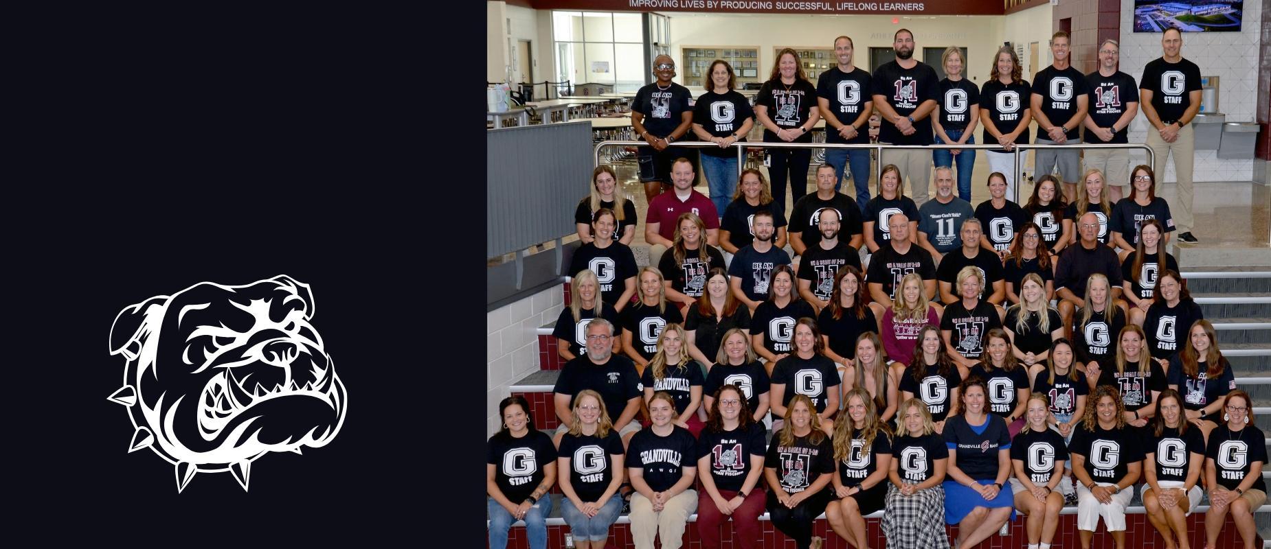 the middle school staff sit on steps in black t-shirts with the G logo