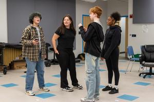 Jae and Hayden chat with two performers in the chorus room
