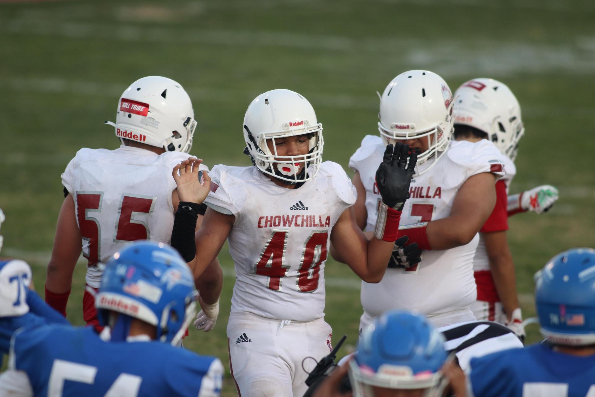 Junior Varsity football players in action against Caruthers