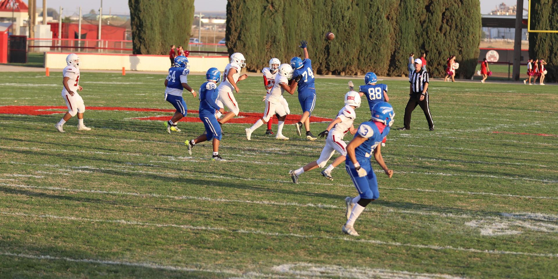 Junior Varsity football players in action against Caruthers