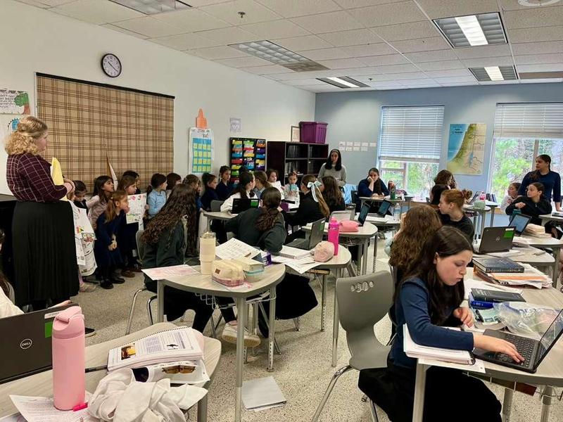 The kindergarten girls speak to the seventh graders to raise money and collect food for Yad Lyad