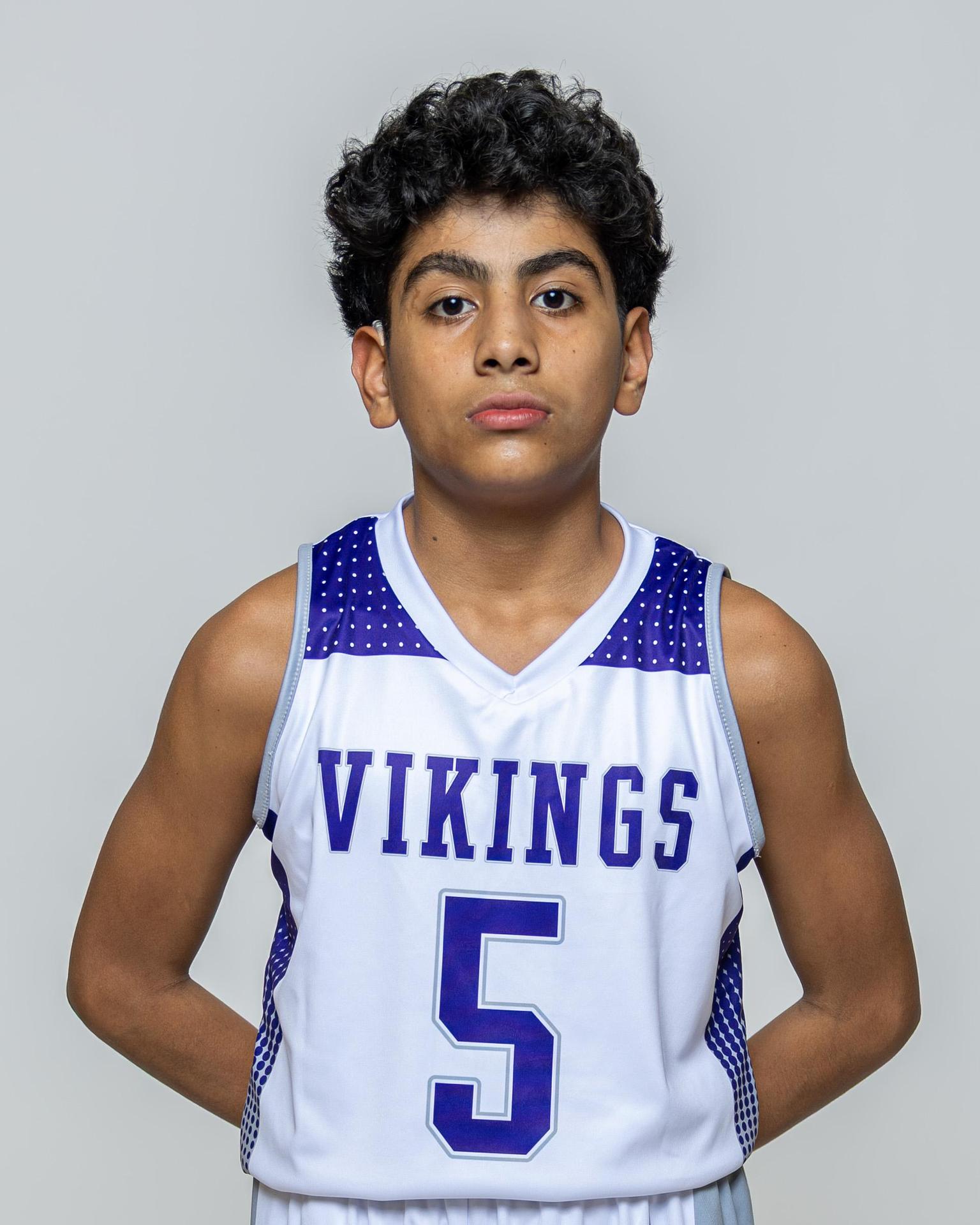 Male player number 5 posing with serious stature for a picture