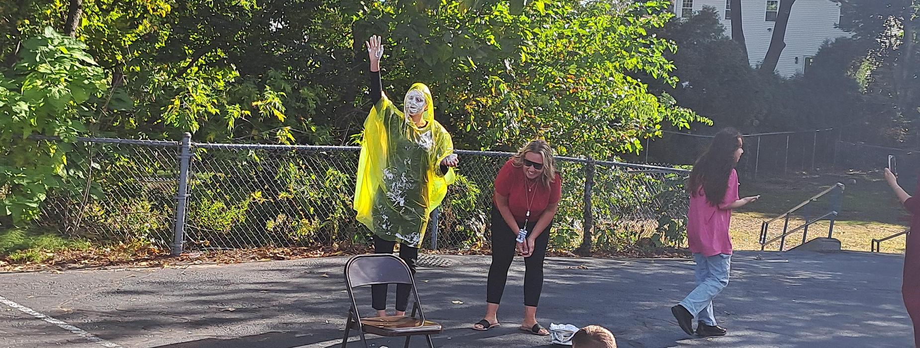 Principal Ashley Cardarelli with whipped cream pie to the face for a Walkathon reward.
