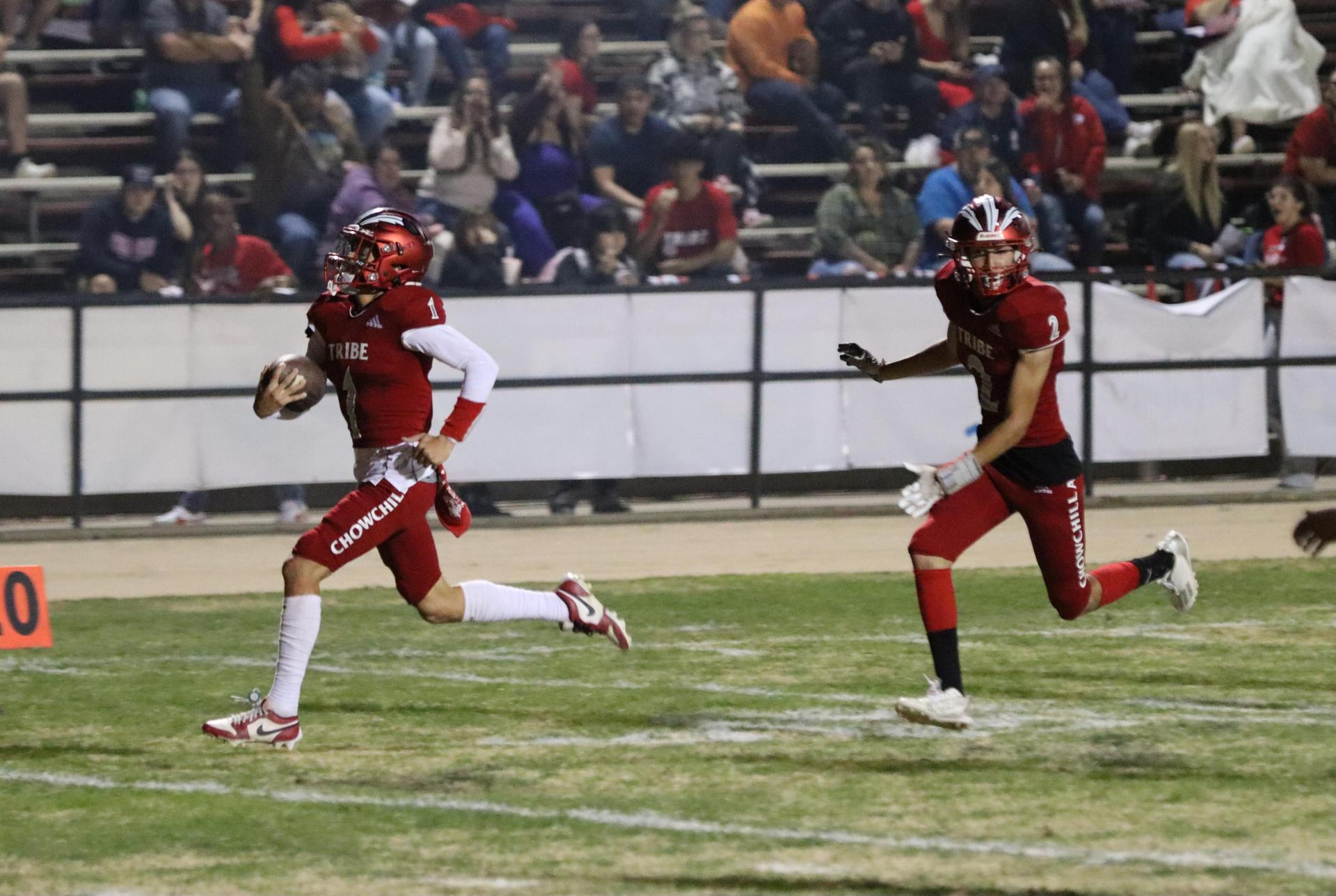 varsity football players in action against Riverdale