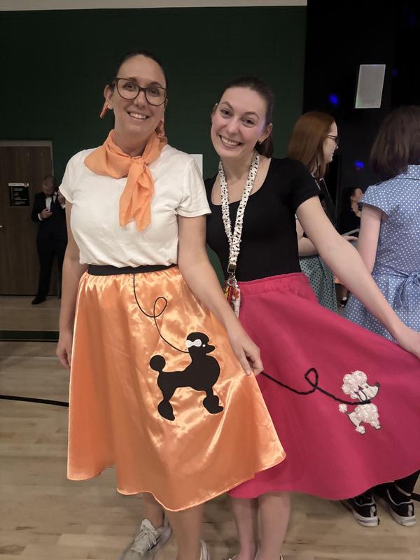 Teachers wearing poodle skirts.