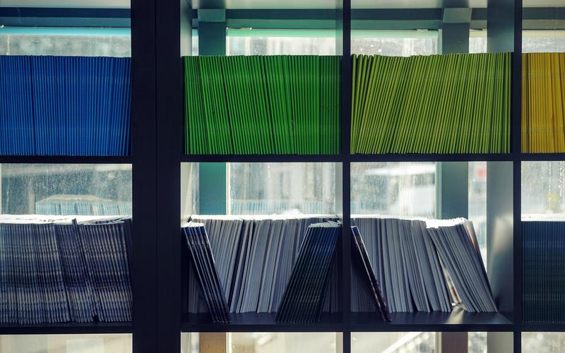 Shelves filled with neatly organized colorful booklets and magazines.