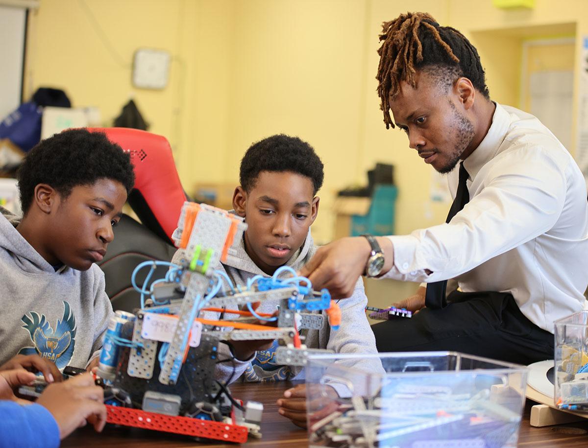 Collage showing students participating in extracurricular activities: aiming in archery, building a robot, and playing the violin in an orchestra