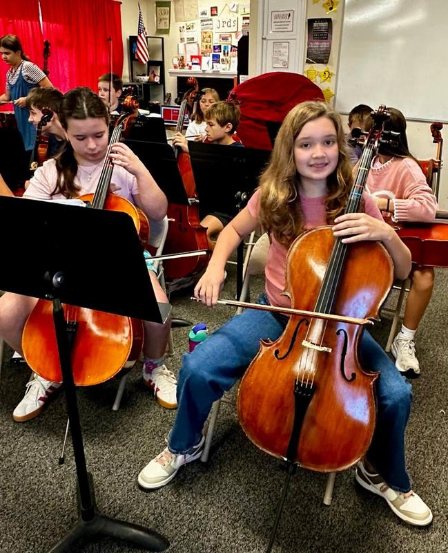 Middle School Orchestra members rehearse for the concert.
