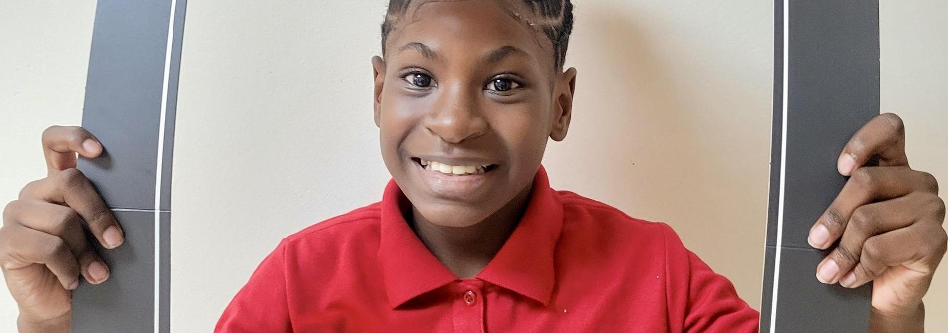 Middle school female African American student enjoys welcoming eveyrone ot the first day of school!