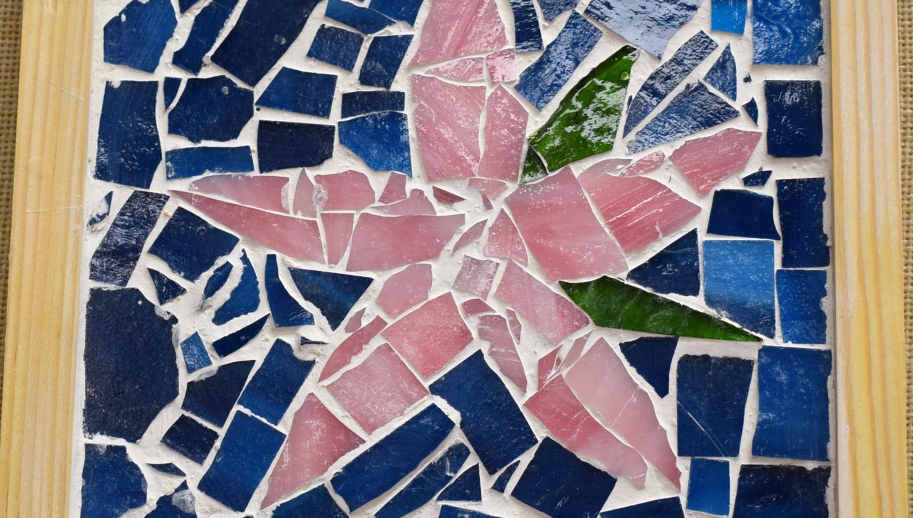 Colorful mosaic featuring a pink star shape surrounded by blue and green tiles.